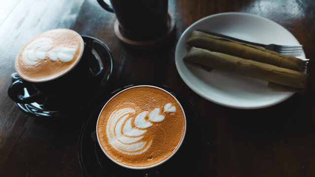 Cappuccino paired with suman malagkit or sweet glutinous rice wrapped in banana leaf for merienda, authentic famous local delicacy in the Philippines