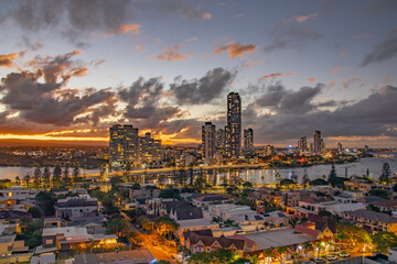 Sunset over the city by the river, city bridge, city lights reflections in the river, Gold Coast,...