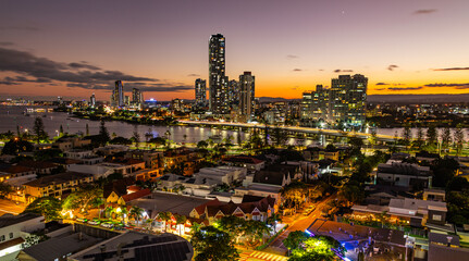 Sunset over the city by the river, city bridge, city lights reflections in the river, Gold Coast,...