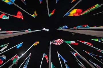 Night view of flags from all over the world - obrazy, fototapety, plakaty