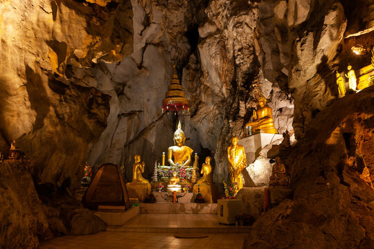 Discover the golden Buddha images nestled within the ancient Pak Piang Cave Temple in Chiang Dao, Thailand.