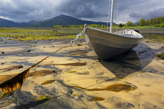 Aluminum Skiff Settles In Sand At Low Tide In Womens' Bay, Kodiak, Alaska