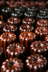 Cannelés,(canneles),traditional French dessert cake, indoor photography studio shot, close-up, clean background