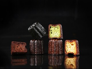 Cannelés,(canneles),traditional French dessert cake, indoor photography studio shot, close up, clean background