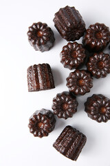 Cannelés,(canneles),traditional French dessert cake, indoor photography studio shot, close-up, clean background