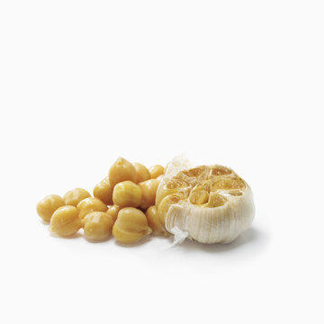 Chick Peas And Cloves Of Garlic On A White Background; Toronto, Ontario, Canada