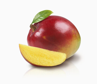 A Mango With A Leaf And A Slice Of Mango On A White Background; Toronto, Ontario, Canada