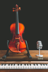 classical violin and retro condenser microphone on old piano. music background - 647497138