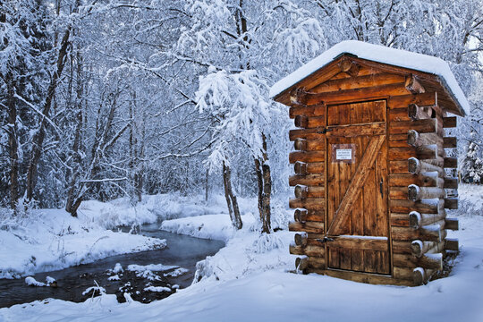 Log Outhouse By A Meandering Creek In Snow, Chena Hot Springs Resort; Fairbanks, Alaska, United States Of America