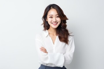 Portrait of an Asian woman with white wall background.