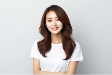 Fototapeta premium Portrait of an Asian woman with white wall background.