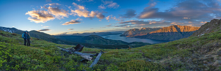 Two women on mountain top enjoying the view along Sam McGee Trail, Yukon, Canada
