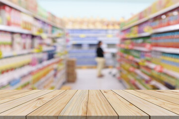 Empty wood table top with supermarket blurred background for product display