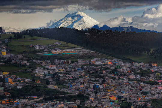 Cotopaxi volcano looms above the hillside town of Quito; Quito, Ecuador