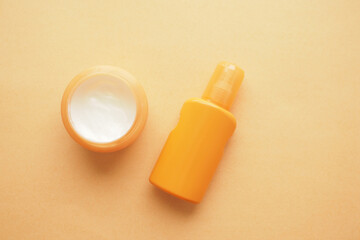 top view of sunscreen cream on a orange color background 