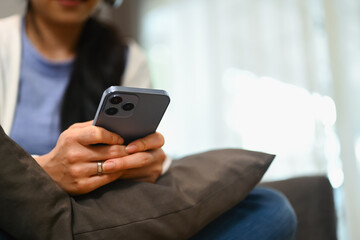 Young woman texting messaging on smartphone. Lifestyle, communicating and technology concept