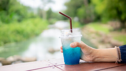 Close up hand holding cold drink 
