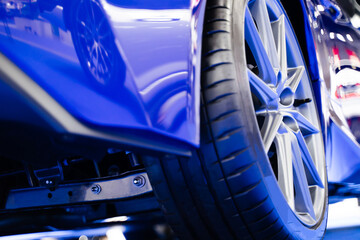 View of the rear of the car, details about the suspension. , blue super sports car wheels, luxury car