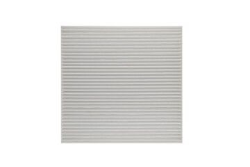 New car air cabin filter element. Car engine air filter texture background. Close-up air filter isolated. Quality spare parts for car service or maintenance