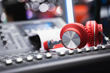 Red over-ear wireless headphones on bokeh light background