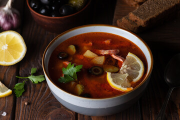 Solyanka soup decorated with lemon slices