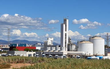 Oxygen plant in Puerto de Sagunto. Chemical factory in industrial area. Chimney smokestack emission. Poor environment. Ecology concept, air and environmental pollution. Natural gas manufacturing