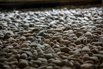 Obraz premium Close-up of a sculpture composed of a pile of stones and pebbles indoors