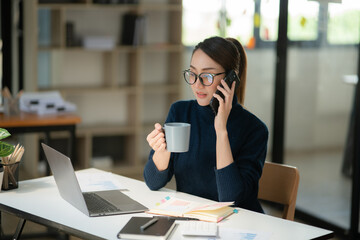 Asian businesswoman working on documents at office