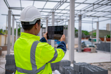 Architect engineer wearing safety uniform survey and working at  structure building site blueprint...