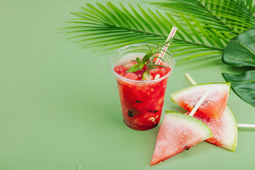 Refreshing watermelon cocktail. Traditional summer drink. Trendy Savannah green background