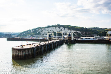 Fototapeta na wymiar leaving dover on a ferry, seeing harbour in the background