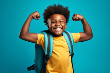 happy winner African American school boy on blue background celebrates new success, power, energy.
