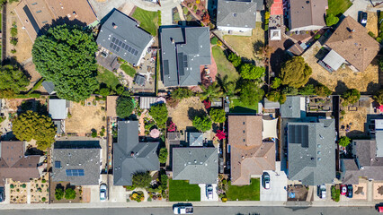 Top down view of houses in a neighborhood in Castro Valley, California with cars houses, streets and yards