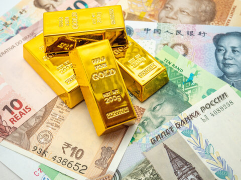 brics countries currency and gold bars concept photo