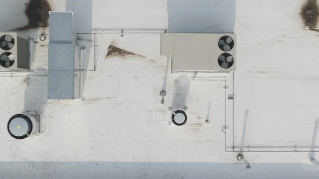 HVAC condenser units at the rooftop of building, aerial dolly shot