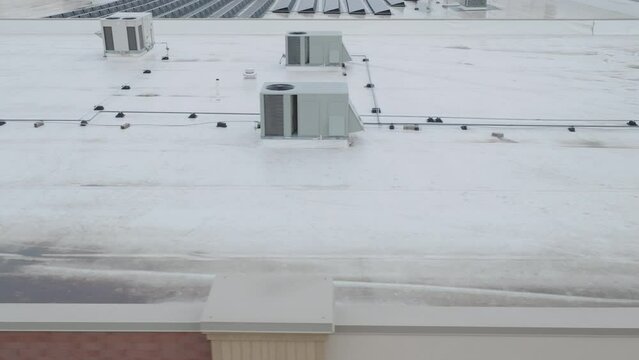 HVAC condenser units at the rooftop of building, aerial dolly shot closeup