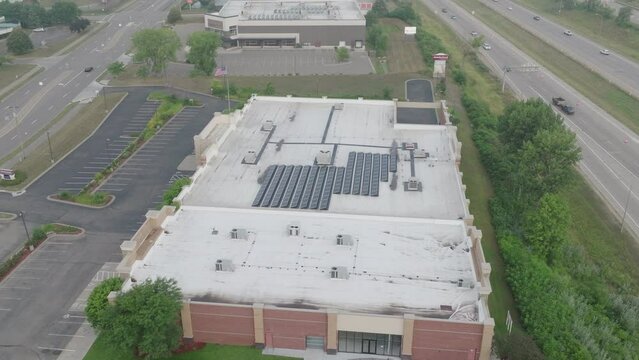 solar panels at the rooftop of building, aerial jib shot