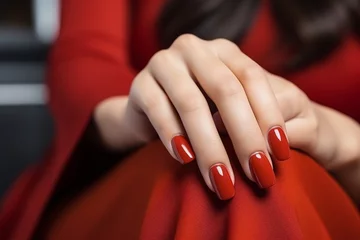 Poster Glamour woman hand with classic red nail polish on her fingernails. Red nail manicure with gel polish at luxury beauty salon. Nail art and design. Female hand model. French manicure. © Artinun