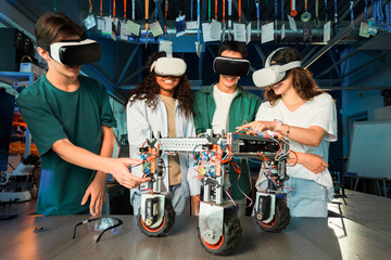 Group of young people in VR glasses doing experiments in robotics in a laboratory