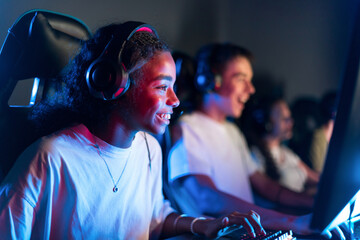 Teen playing in video game club