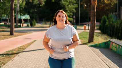 Woman with overweight running in a park