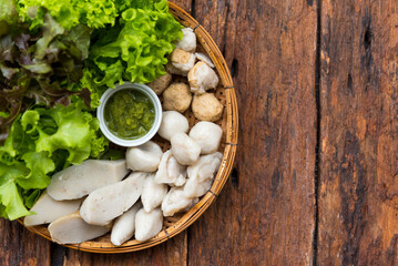 Fish balls with Thai seafood dipping sauce recipe and salad vegetables on wood background, Asian food, Street food, Thai food.