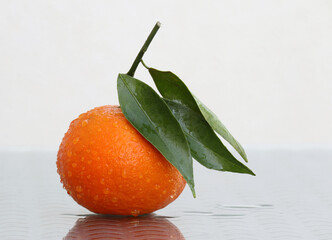 Ripe mandarin with water drops - 647539745