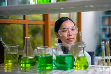 Asian woman scientist plant science laboratory research, biological chemistry test, green nature organic leaf experiment in test tube.