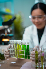Asian woman scientist plant science laboratory research, biological chemistry test, green nature...