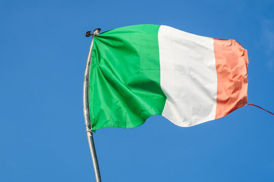 Italian Italy flag hanging waving wind blue sky tricolor green