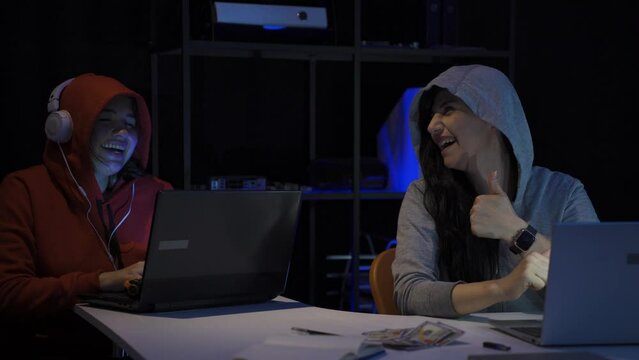 Hacker slyly laughing, doing cyber attack.