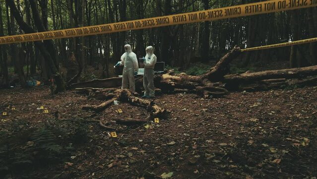 Forensic police investigators arriving at a crime scene and assessing the situation. Aerial drone shot. variety of shots in gallery