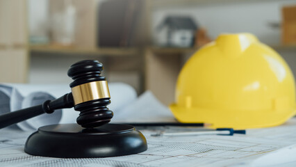 Labor and Construction law concept.judge gavel with yellow safety hat,blueprint,home model backgound.Government service protecting safety at job. Worker security protection policy. - obrazy, fototapety, plakaty