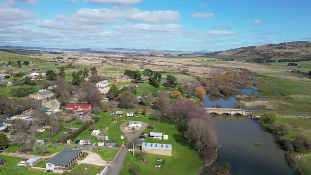 Ross, Australia: Aerial drone footage of the historic ancient Ross town in Tasmania, famous for its stone bridge over the river Macquarie dating from the colonial time. 